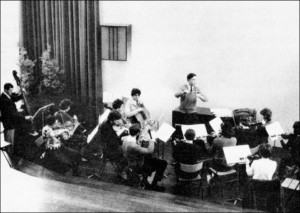 Paul Shepherd conducting a group of musicians in the Music Salon.